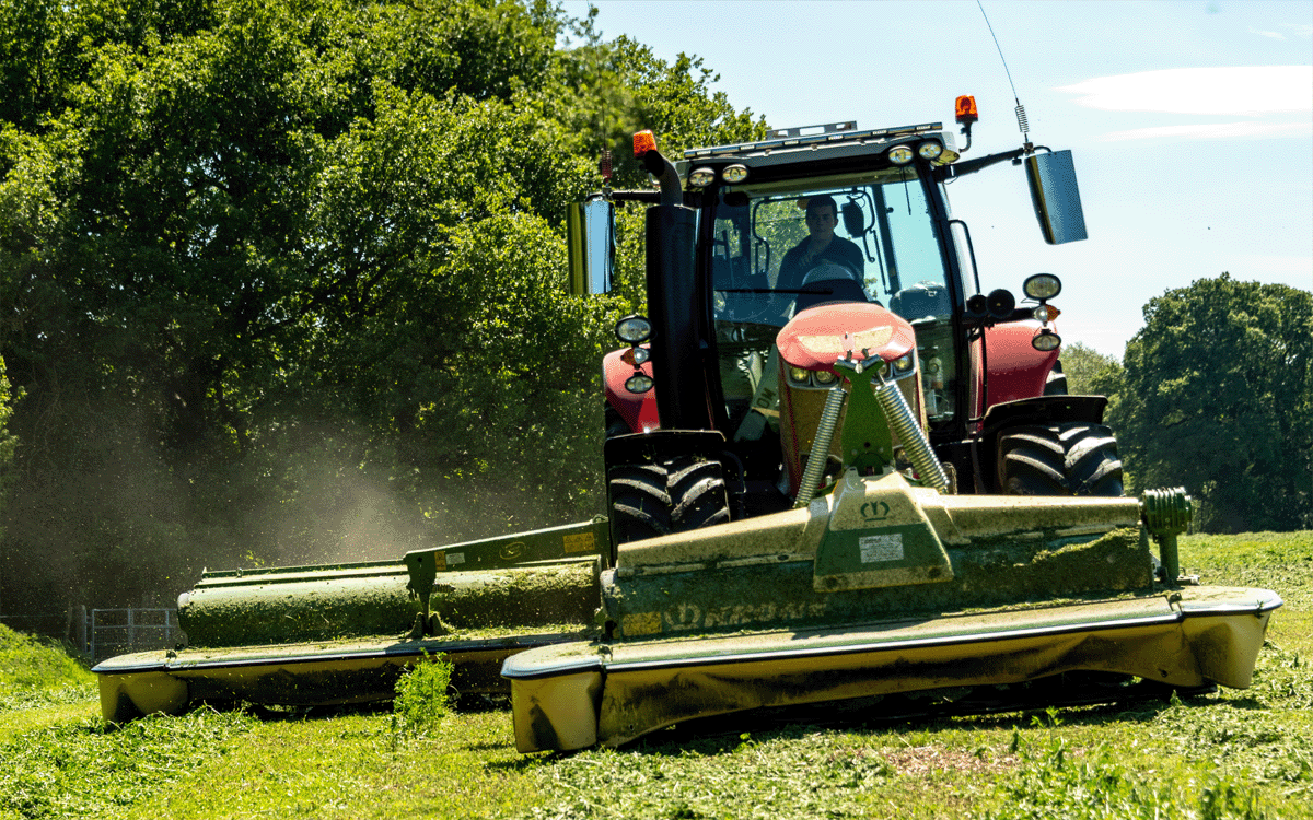 Tractor mowing sainfoin for dairy cow silage with Krone mowers in Shropshire